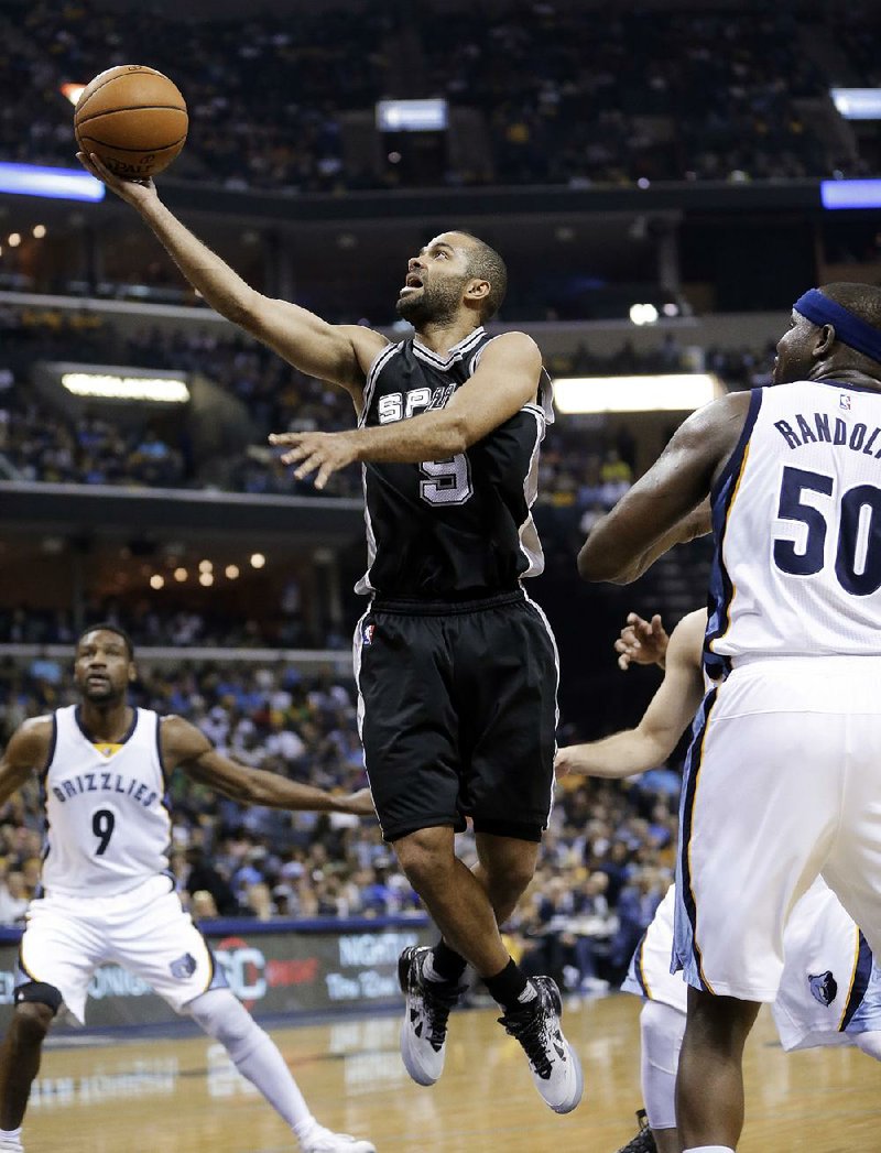 San Antonio guard Tony Parker (left) drives around Memphis forward Zach Randolph during Sunday’s NBA playoff game. Parker scored 16 points to help the Spurs advance to the Western Conference semifinals with a 116-95 victory.