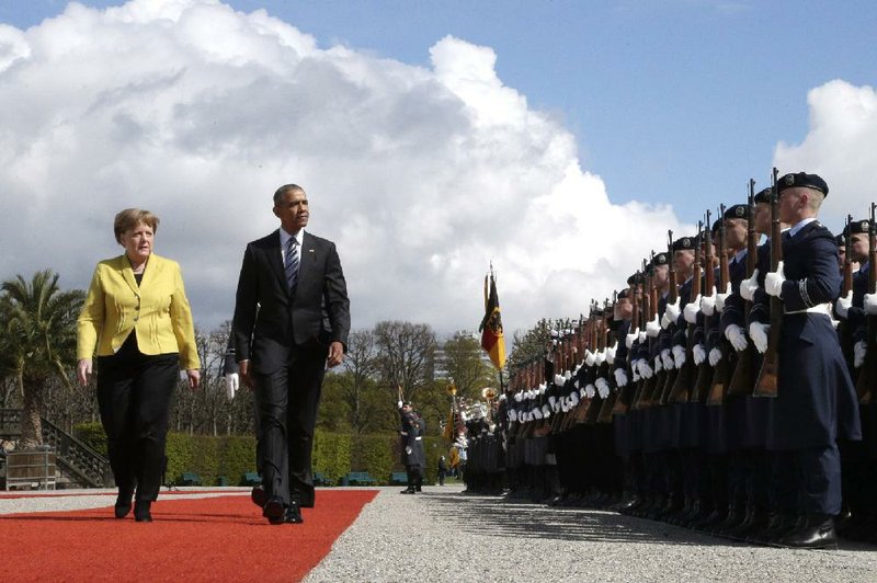 German Chancellor Angela Merkel and U.S. President Barack Obama review the honor guard at Herrenhausen Palace in Hanover, Germany, on Sunday.