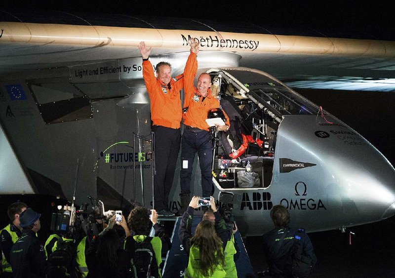 Solar Impulse 2 pilots Bertrand Piccard (right) and Andre Borschberg celebrate after Piccard landed their solar-powered plane at Moffett Field in Mountain View, Calif., on Saturday.