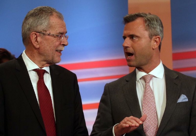 Alexander Van der Bellen (left), candidate of the Austrian Greens, talks with Norbert Hofer of Austria’s Freedom Party during the release of the first results of the Austrian presidential election in Vienna on Sunday.