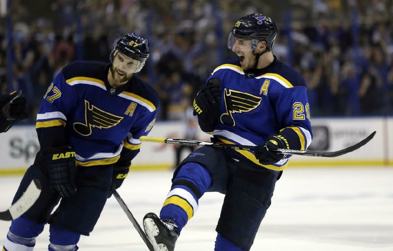 St. Louis’ Alexander Steen (right) and Alex Pietrangelo celebrate after the Blues’ 3-2 victory over the Chicago Blackhawks on Monday in Game 7 of their NHL Western Conference playoff series.