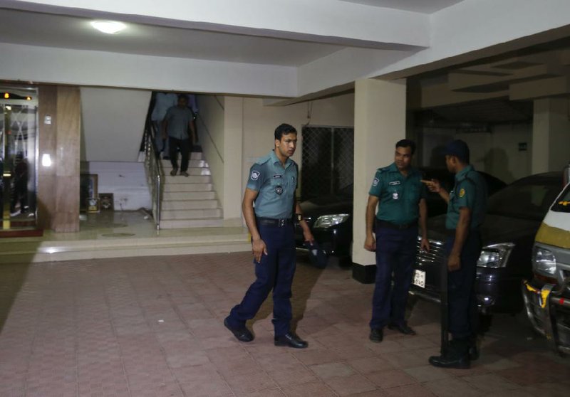 Bangladeshi police arrive at a building where two people were found stabbed to death in Dhaka, Bangladesh, on Monday.