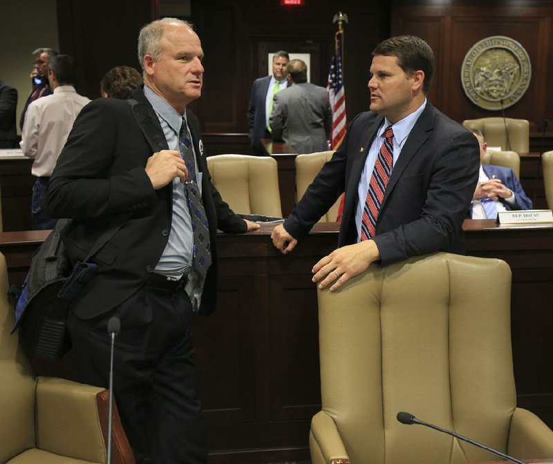 Sen. Jim Hendren (left), R-Sulphur Springs, talks with Sen. Bart Hester, R-Cave Springs, Thursday after the Joint Budget Committee failed to pass an amendment that would strike Arkansas Works from a bill to fund the state’s expanded Medicaid program.