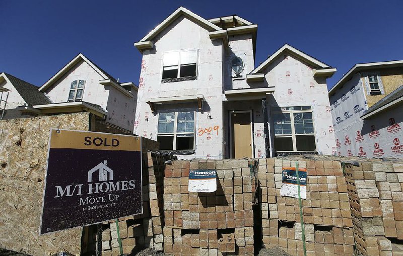 Construction nears completion for homes going up in Plano, Texas, in February. New-home sales slipped 1.5 percent in March, the Commerce Department said Monday.