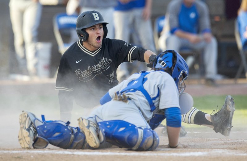 Bentonville sophomore Tyler Johnson reacts after getting tagged out at home by Rogers catcher Jackson Field on Monday, April 25, 2016, at Veterans Park in Rogers.