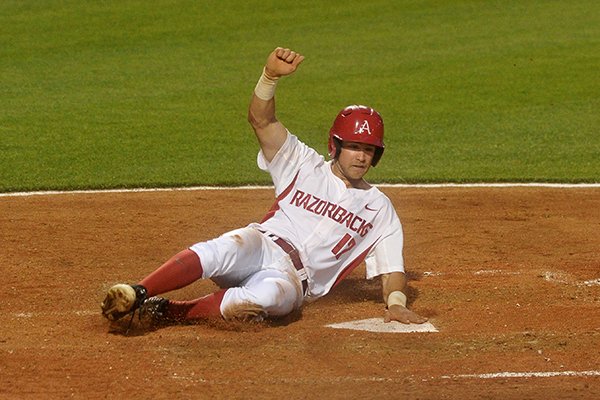 Arkansas' Luke Bonfield scores a run during the seventh inning of a game against Oklahoma State on Tuesday, April 26, 2016, at Baum Stadium in Fayetteville. 