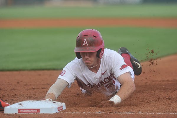 Arkansas outfielder Carson Shaddy slides into first base during a game against Oklahoma State on Tuesday, April 26, 2016, at Baum Stadium in Fayetteville. 