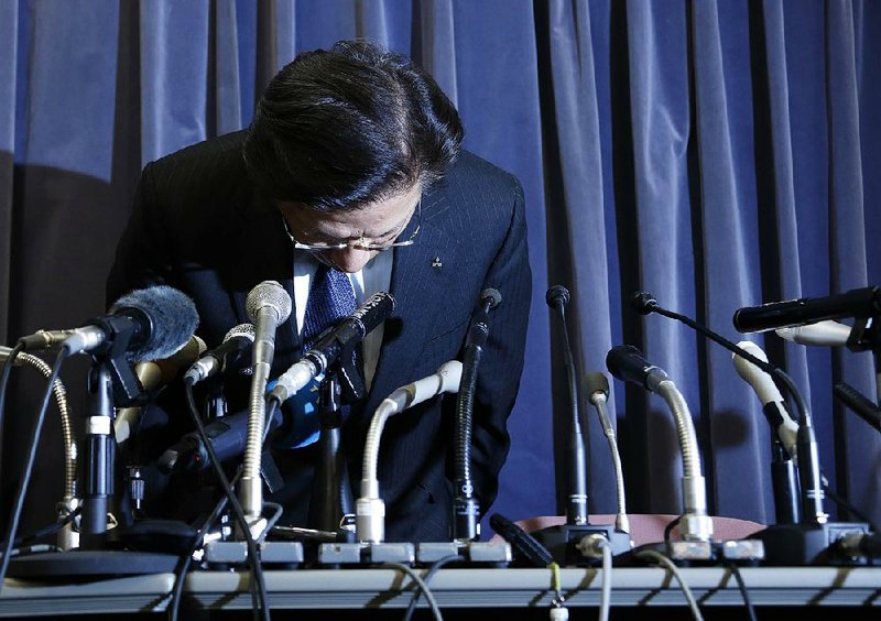 Tetsuro Aikawa, president and chief operating officer of Mitsubishi Motors Corp., bows Tuesday at a news conference in Tokyo. 