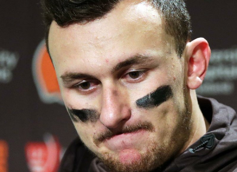 In this Dec. 20, 2015, file photo, Cleveland Browns quarterback Johnny Manziel speaks with media members following the team's 30-13 loss to the Seattle Seahawks in an NFL football game in Seattle. Former Cleveland Browns quarterback Johnny Manziel was indicted by a grand jury on Tuesday, April 26, 2016, on misdemeanor charges stemming from a domestic violence complaint by his ex-girlfriend. 