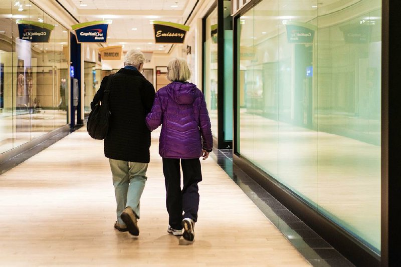 Mall walkers Ann Morales and Flora Yang walk together at Mazza Gallerie in Washington; Yang walks twice a week at the mall and says mall walking keeps her youthful and fit. 