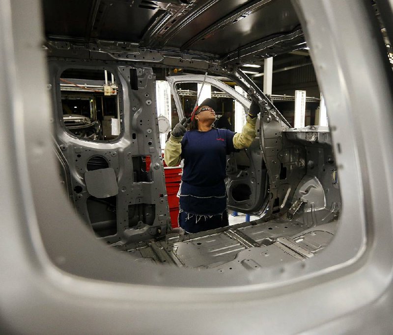 A production-line worker prepares the door frame of a Titan pickup for painting at the Nissan Canton Vehicle Assembly Plant in Canton, Miss., earlier this month. Orders for durable goods increased 0.8 percent in March, the Commerce Department said Tuesday. 