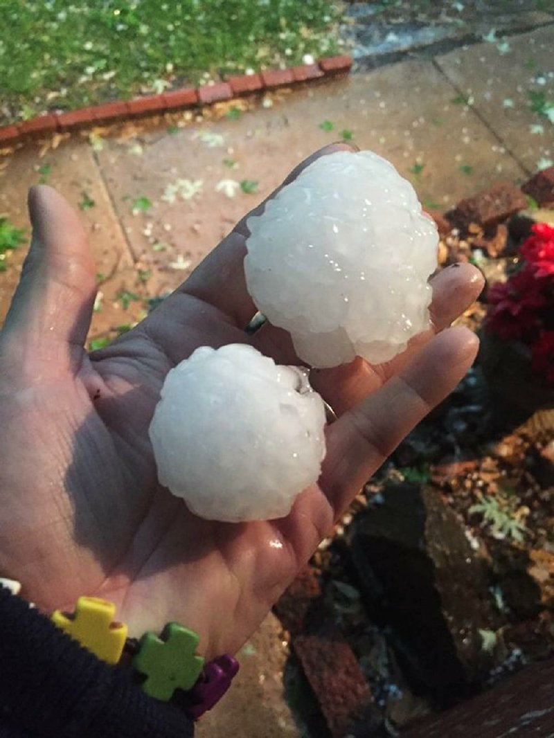 Susan Goodwyn holds hail in her hand Tuesday in Wichita, Kan. 