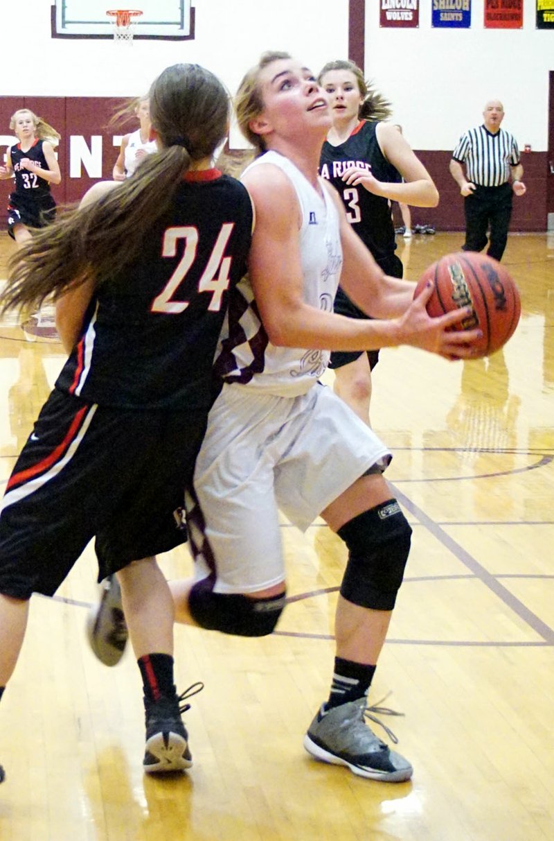 File Photo by Randy Moll Haley Borgeteien-James moves around a Pea Ridge defender to shoot under the basket during play this past season at Gentry.