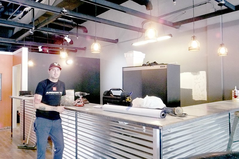 Lynn Atkins/The Weekly Vista General Manager Josh Milton of GPP Cycling poses at the counter of the company&#8217;s newest retail store in Sugar Creek Center. He expects to open in early May.