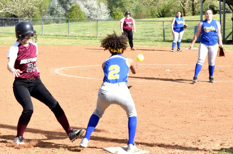 Photo by Mike Eckels A throw by Decatur pitcher Cameron Shaffer reaches Desi Meek, third baseman, a second before a Hartford runner reaches the plate at Edmiston softball field in Decatur on April 21.