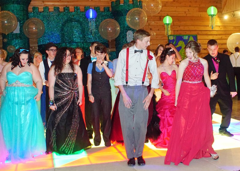Photo by Randy Moll Attendees at the Gentry High School prom held Saturday at the Cypress Barn in Siloam Springs got started on the dance floor with a line dance.
