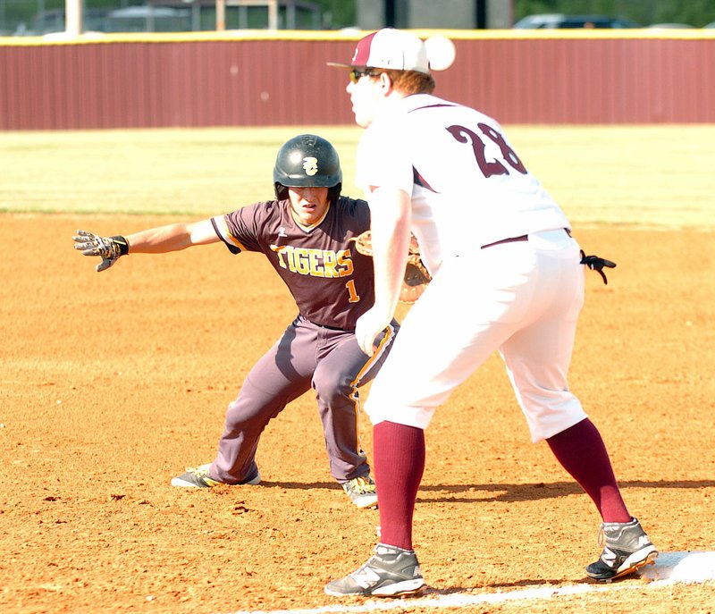 Photo by Mike Capshaw/Enterprise-Leader Prairie Grove&#8217;s Clay Fidler dives back to the bag on a pick-off attempt while Lincoln&#8217;s Zach Duncan covers first base during the Tigers&#8217; 19-5 win on April 21. Fidler eventually came around to score during a four-run first inning.