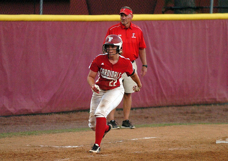 Photo by Mike Capshaw/Enterprise-Leader Farmington&#8217;s Callie Harper takes an aggressive lead off of third base as coach Randy Osnes looks on. Harper reached base when she hit a two-run single to tie the score at 2-all in the sixth inning of Farmington&#8217;s 3-2 victory against Vilonia on April 19.