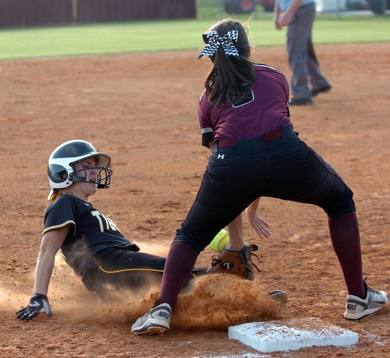 Photo by Mike Capshaw/Enterprise-Leader Prairie Grove&#8217;s Katharine McConnell slides into third base ahead of the tag by Lincoln&#8217;s Tristan Cunningham. McConnell would go on to score the Lady Tigers&#8217; first run during the game, which Lincoln won 7-3.