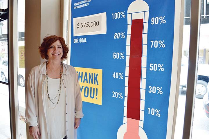 Maret Cahill-Wicks, executive director of the United Way of Central Arkansas, stands next to the campaign thermometer in the agency’s headquarters in downtown Conway. She said $40,000 is still needed to meet the $575,000 goal to fund programs in 20 agencies in Faulkner and Perry counties.