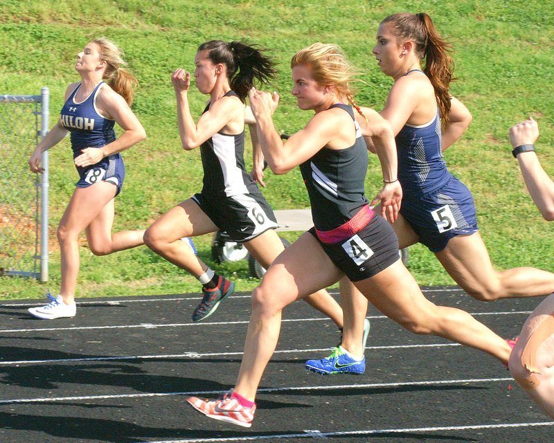 Jordan Neeley (No. 4), Gravette senior, runs with determination at the start of the 100-meter dash in Gravette on Tuesday. She won the event with a time of 13.19. Vanessa Wing of Pea Ridge (No. 6) finished second with a time of 13.34.