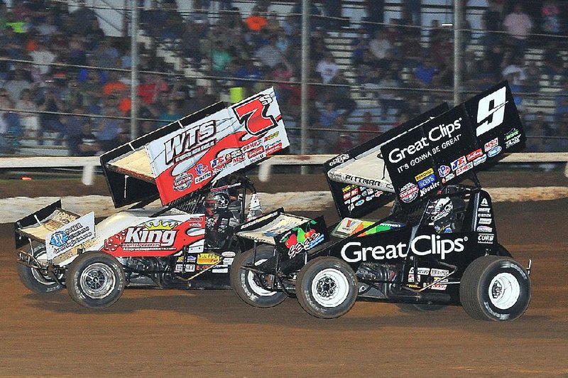 Jason Sides (7) of Bartlett, Tenn., drives past Daryn Pittman of Owasso, Okla., on a late-race restart during Tuesday night’s World of Outlaws sprint car event at Little Rock’s I-30 Speedway. Sides won to earn his 15th career Outlaws victory.