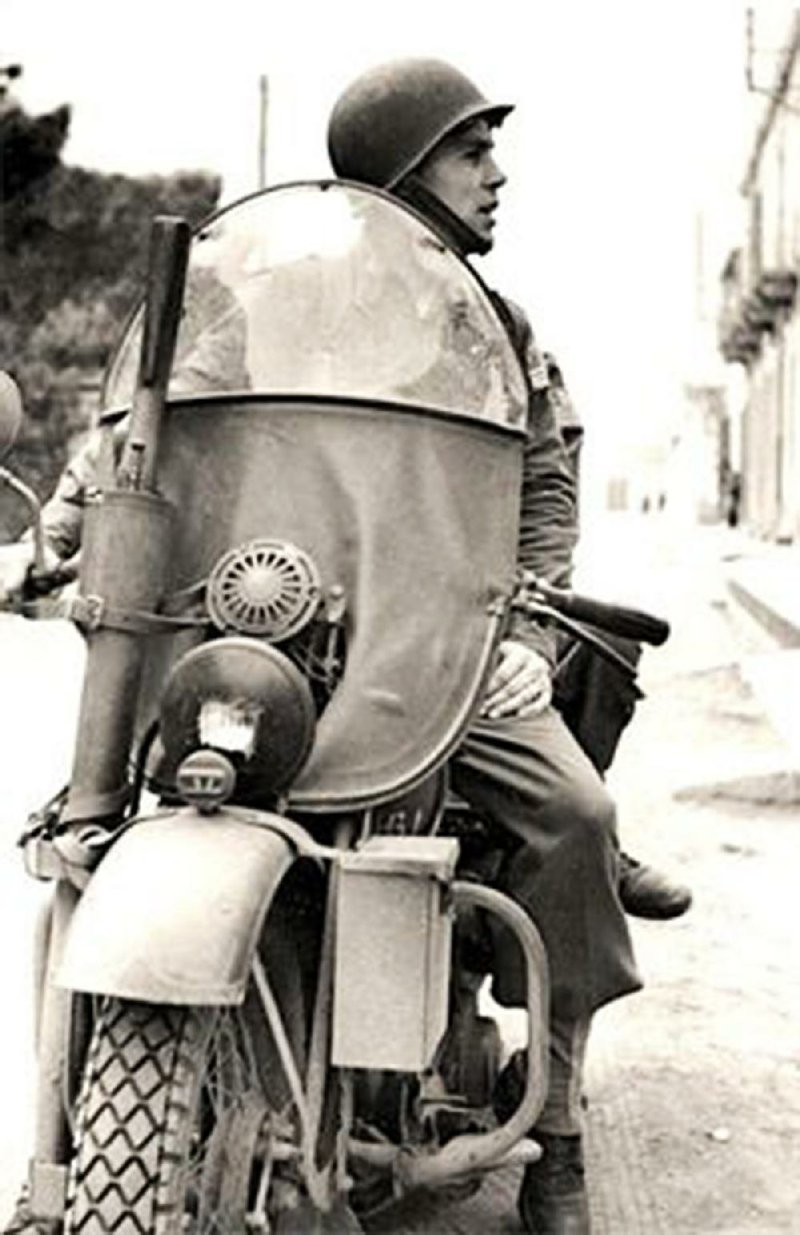 William O. Darby sits on his Harley-Davidson motorcycle in Italy in this undated photo. 