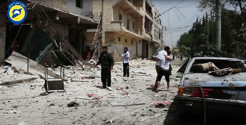 This image from video posted online by the Syrian Civil Defense White Helmets shows the aftermath of airstrikes and artillery barrages Sunday in the Syrian city of Aleppo, where dozens of civilians have been killed in the past week. 
