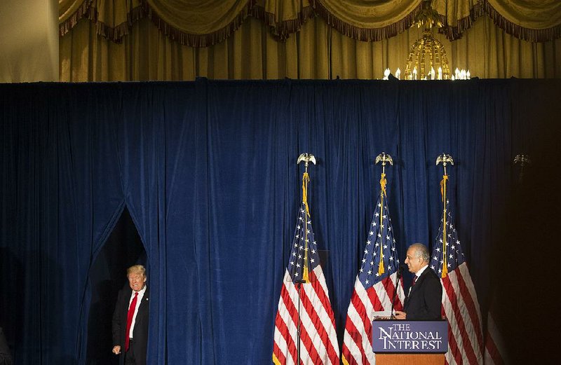 Donald Trump emerges from behind a curtain Wednesday at the Mayflower Hotel in Washington to give his foreign-policy address after an introduction by Zalmay Khalizad, a former U.S. ambassador to Iraq, Afghanistan and the United Nations. 