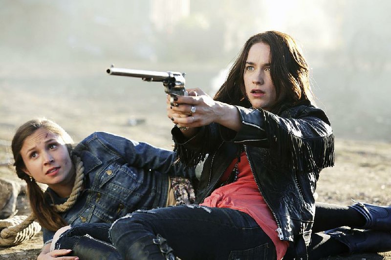 Syfy’s new horror/adventure series Wynonna Earp stars Dominique Provost-Chalkley (left) and Melanie Scrofano as the demonbusting Earp sisters.
