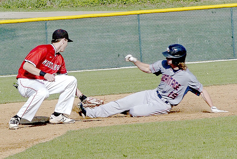 Photo by Rick Peck McDonald County shortstop Dagan Stites tags out Garrett Carmical of Rogers Heritage as he attempts to steal second base during the War Eagles&#8217; 1-0 win on April 21 in Rogers.