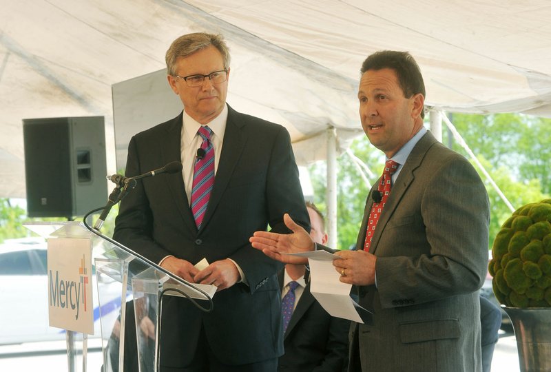 Steve Goss, Mercy Clinic president, and Eric Pianalto, Mercy Hospital president, speak Wednesday during a news conference in Rogers announcing plans to invest $247 million on capital projects and equipment over the next five years. The expansion includes a new patient tower adding more than 100 beds to the Rogers hospital and new clinics in Benton and Washington counties.
