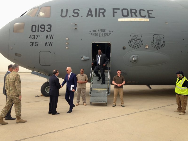 Vice President Joe Biden is greeted by U.S. Ambassador Stuart Jones after stepping off a C-17 military transport plane upon his arrival in Baghdad, Iraq, Thursday, April 28, 2016. Biden arrived in Baghdad on a visit intended to help Iraqi leaders resolve a political crisis that has hindered efforts to defeat the Islamic State group. (AP Photo/Josh Lederman)
