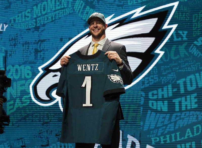 North Dakota State’s Carson Wentz poses for photos after being selected by the Philadelphia Eagles as second pick in the first round of the 2016 NFL football draft, Thursday, April 28, 2016, in Chicago. 
