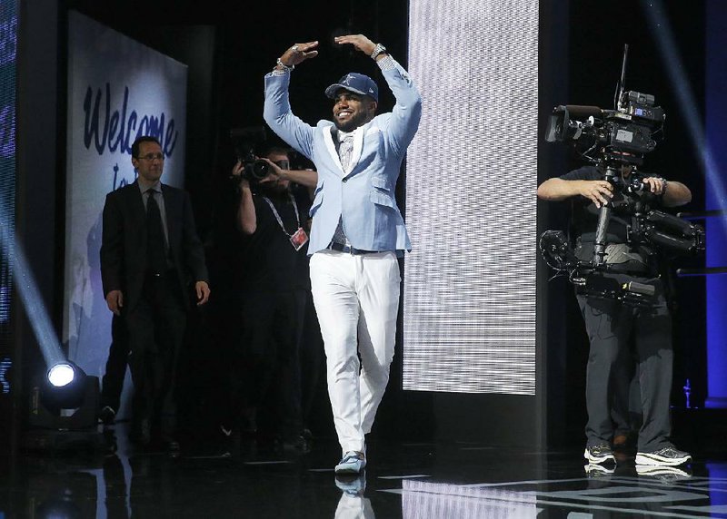 Running back Ezekiel Elliott of Ohio State gestures to fans after Dallas grabbed him with the No. 4 pick in the first round of the NFL Draft on Thursday.