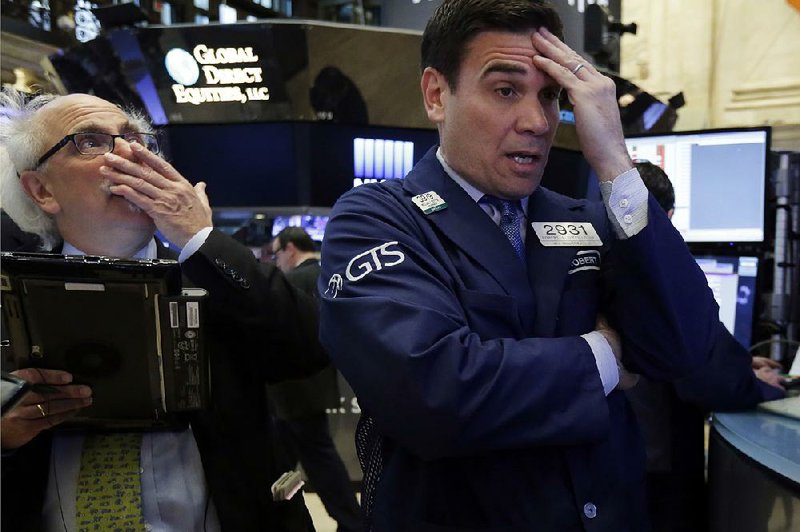 Trader Peter Tuchman (left) and specialist Robert Tuccillo work Thursday on the floor of the New York Stock Exchange.