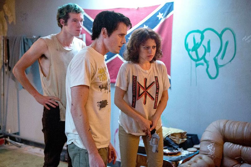 Tiger (Callum Turner), Pat (Anton Yelchin) and Sam (Alia Shawkat) make up three-quarters of the Ain’t Rights, a punk band that encounters trouble a long way from home in Jeremy Saulnier’s plausible horror film Green Room.