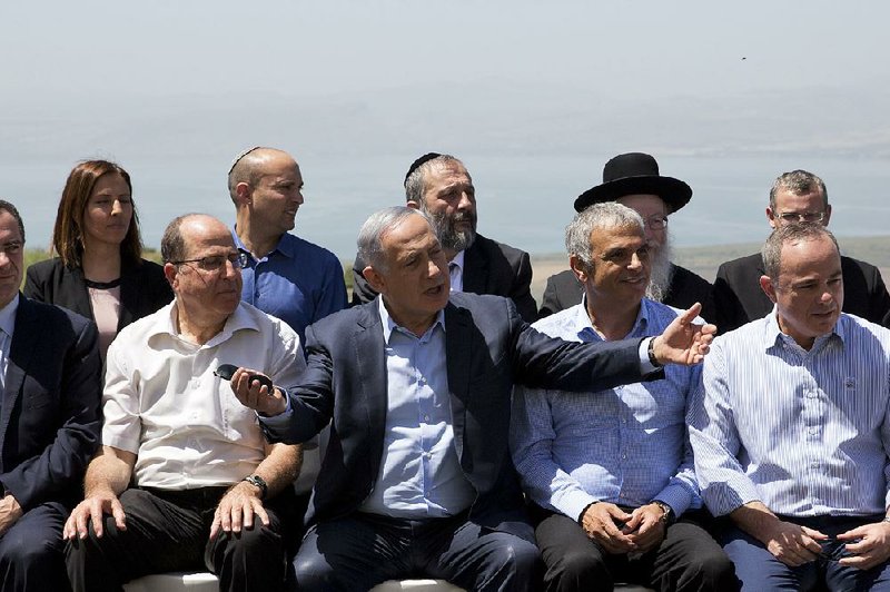 Israeli Prime Minister Benjamin Netanyahu (center) poses Sunday with Cabinet ministers in the Israeli-controlled Golan Heights, which was seized from Syria in the 1967 war.