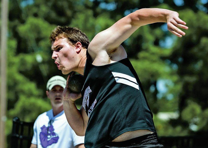 Fayetteville’s Blake Young competes in the shot put Thursday during the 7A-West conference track meet at Ramay Junior High in Fayetteville.