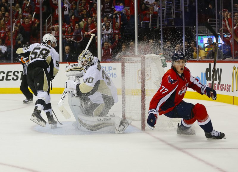 Washington Capitals right wing T.J. Oshie (77) starts to celebrate his goal against Pittsburgh Penguins goalie Matt Murray (30) and Kris Letang (58) during the second period of Game 1 in an NHL hockey Stanley Cup Eastern Conference semifinals Thursday, April 28, 2016 in Washington.