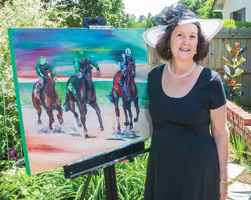 CASA volunteer Helen Pate stands by a painting by Barbara Smock of Newport that she sold to CASA for its first Derby Day fundraiser.