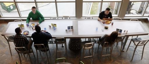 Students at the University of New Hampshire have lunch at the new $17,000 custom-made chef's table at the campus dining hall Friday, April 29, 2016, in Durham, N.H. 