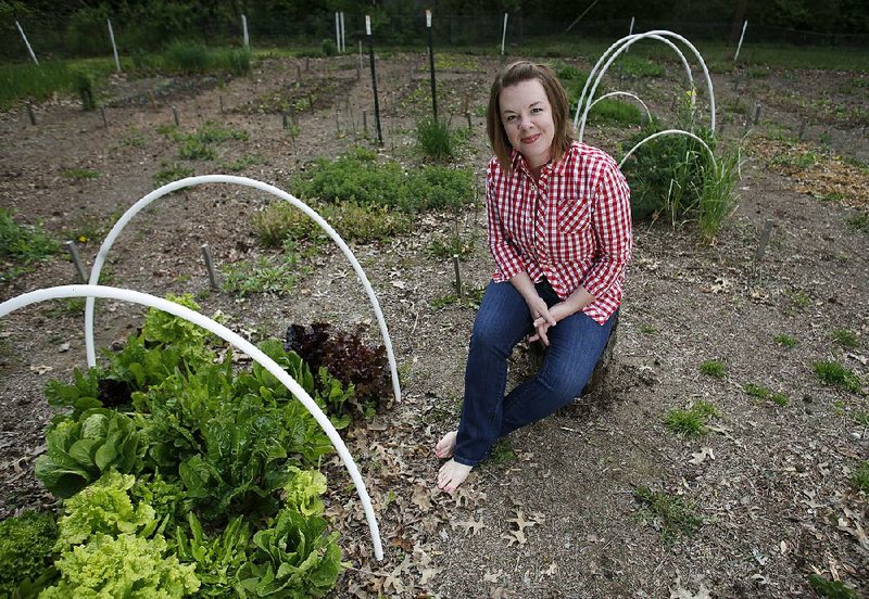 Tiffany Selvey sits in her favorite personal space Thursday, April 14, 2016, the vegetable garden in the backyard of her home in Springdale.
