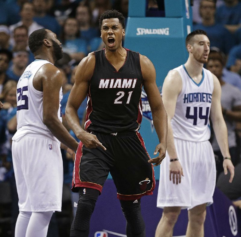 Miami forward Hassan Whiteside reacts after making a basket late in Friday’s NBA playoff game against Charlotte. Whiteside had 12 points, 7 rebounds and 4 blocks as the Heat beat the Hornets 97-90 to force a Game 7 in their first-round series.