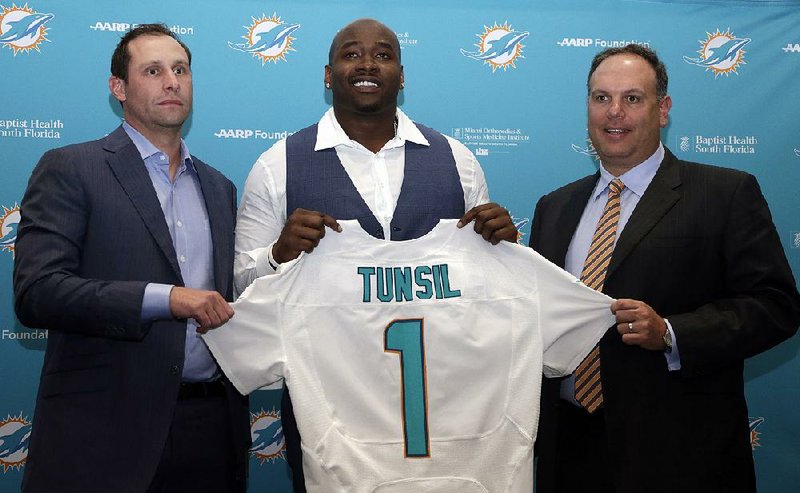 Offensive lineman Laremy Tunsil holds a Miami Dolphins jersey during his introductory news conference Friday.
Tunsil was taken 13th by the team in the first round of the NFL Draft on Thursday.