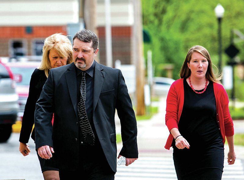 Former Benton County Sheriff Kelley Cradduck walks to the Benton County Courthouse on Friday in Bentonville. Cradduck pleaded no contest to a misdemeanor tampering charge and received six months on probation and a $500 fine.