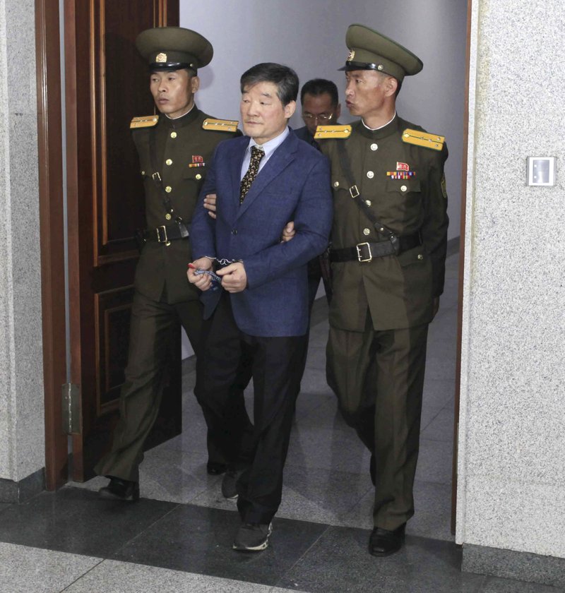 Kim Dong Chul, center, a U.S. citizen detained in North Korea, escorted from the court room after his trial Friday, April 29, 2016, in Pyongyang, North Korea. 