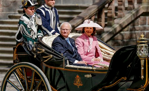 Sweden's Queen Silvia and King Carl XVI Gustaf arrive in an open carriage for lunch at Stockholm City Hall as part of the celebration for the king's birthday in Stockholm on Saturday, April 30, 2016. 