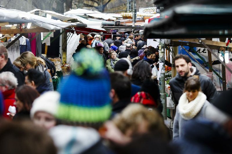 People crowd the Turkish market in Berlin’s Neukoelln district in March. Germany is home to at least 3 million Turkish immigrants, but many face struggles in school and in the job market. 
