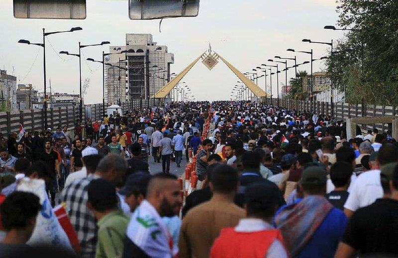Supporters of Iraqi Shiite cleric Muqtada al-Sadr surge across the al-Jumhuriya bridge over the Tigris River on Saturday toward the heavily guarded Green Zone and the Iraqi parliament building. 